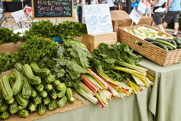 Display of zucchini, frisee and Swiss chard for sale at a Farmers Market in Boulder, Colorado