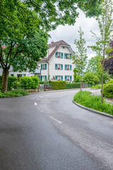 Fototapeta na wymiar A perfect neighbourhood. Houses in suburb at Summer in Lucerne, Switzerland. Luxury houses with nice landscape.