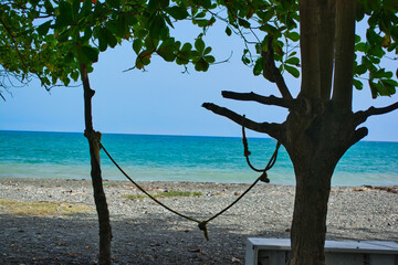 Crisp photo of ocean shot under a calm cool shade on the beach front from the beautiful island of Jamaica. The cool breeze caresses the calm waves creating a stunning scene