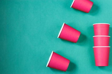 Paper cups on a mint background. Ecological tableware. Minimalistic style. Top view.