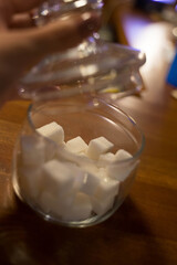 transparent glass jar with white sugar on the table