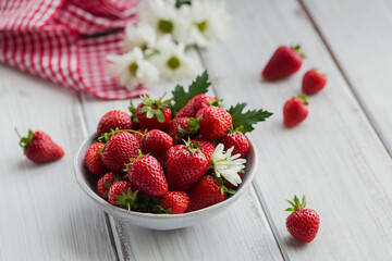 Heap of fresh strawberries in ceramic bowl on white background. Healthy eating and diet food concept.