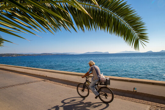 Popular transport on island Spetses -    relative ecological - mopeds   ( unrecognizable person)