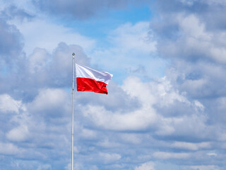 on flagpole the red and white flag of Poland is waving