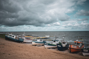 Fototapeta na wymiar At Beach of Jaroslawiec in Poland fishing boats lie on the beach of the Baltic Sea
