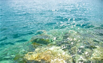 Fototapeta na wymiar Clear blue sea water and stone background