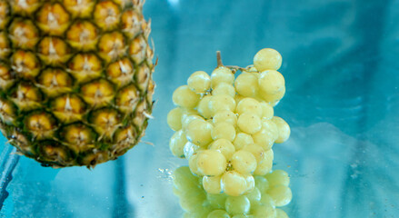 pineapple and grapes dipped in water at the same time 