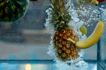 fruit pineapple and banana thrown into the water, bubbles appeared 