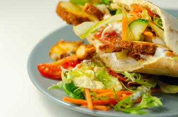 Mediterranean style pitta prepared with spicy chicken, cucumber, tomato, salad and mayo sauce