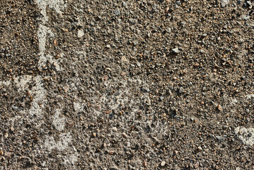 part of the old markings on the asphalt are visible through the stones of the broken road 