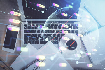 Double exposure of map hologram drawing over study table background with computer. Concept of international network. Top view.