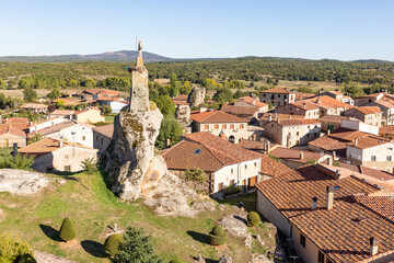 Fototapeta premium a view over Hacinas town and the Statue of Christ on top of a boulder, province of Burgos, Castile and Leon, Spain