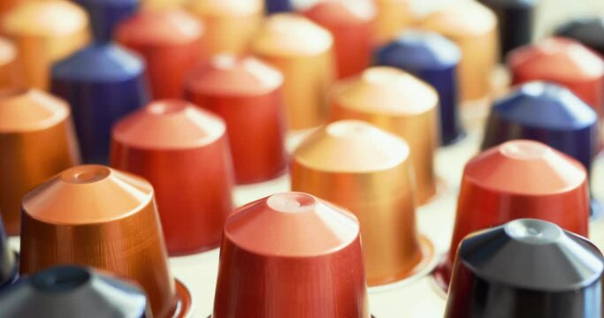 Tracking shot of several coffee capsules
