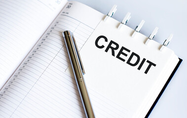 text CREDIT on the short note texture background with pen