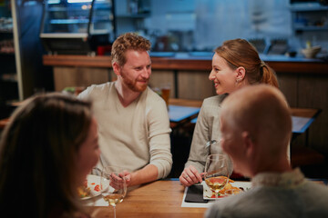 Group of friends having fun at restaurant.