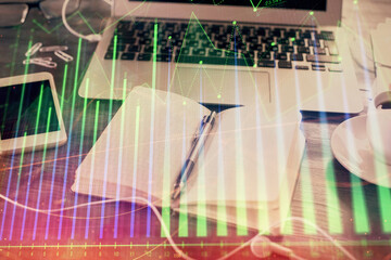 Multi exposure of financial graph drawings and desk with open notebook background. Concept of forex