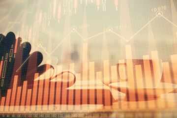 Double exposure of financial chart drawing and desktop with coffee and items on table background. Concept of forex market trading