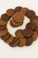 Milky and bitter round shape chocolate Madlen,designed on glass plate.The Sugar Feast or any festival celebration,vertical image.