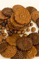 Milky and bitter round shape chocolate Madlen,designed on glass plate,at black background with copy space.Top view.