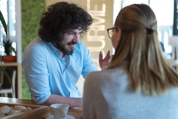 Startup Diversity Teamwork Brainstorming Meeting Concept.Two Business Coworkers discussing about Economy situation in their companies. People Working Planning Start Upand  Discussing inside Cafe bar.