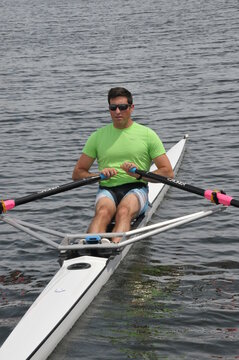 Rower and his single scull (shell) going out for some exercise on the water.