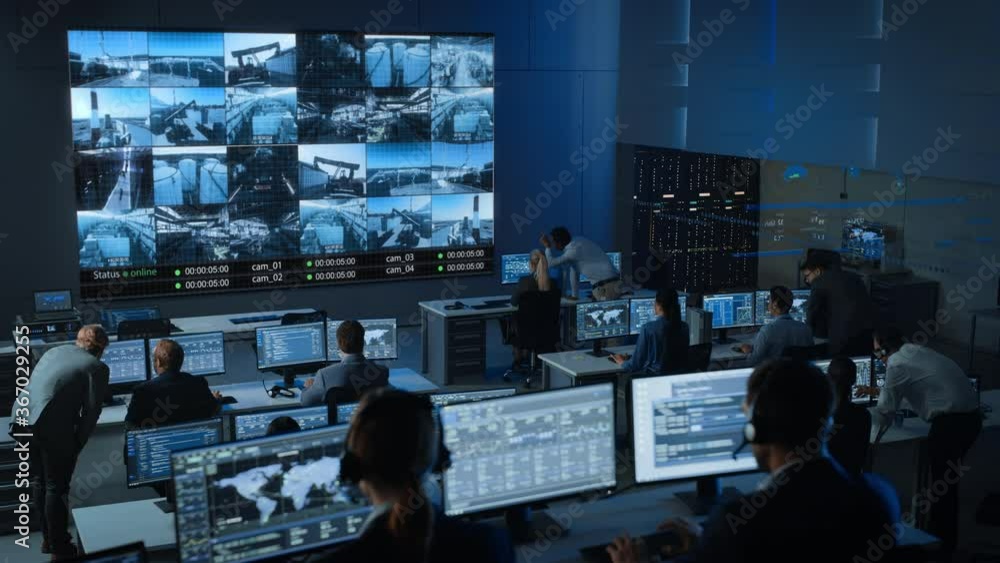 Leinwandbilder static shot of a group of professionals working in a surveillance control center with cctv video foo