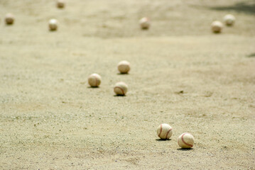 Fototapeta na wymiar 甲子園を目指した部活の練習後にグラウンドに転がった複数の野球ボール
