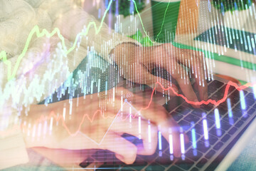 Double exposure of woman hands typing on computer and forex chart hologram drawing. Stock market invest concept.