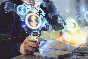 Double exposure of man's hands holding and using a phone and financial graph drawing. Analysis concept.