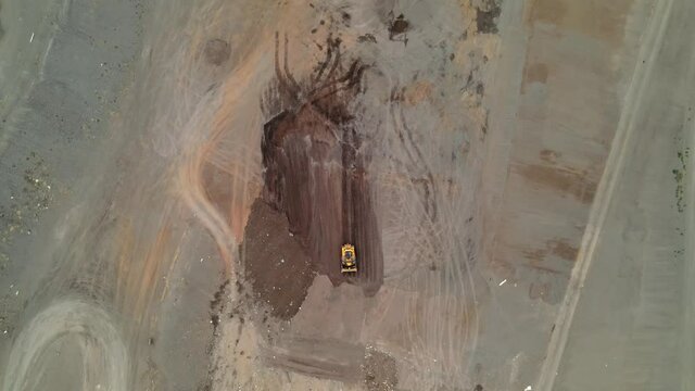 Drone aerial shot 4k. Landfill compactor bulldozer. Waste management, trash dump, pollution, recycling plant, trash landfill.