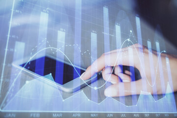 Double exposure of forex chart sketch hologram and woman holding and using a mobile device. Financial market concept.