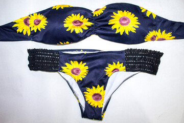 black swimsuit with yellow floral pattern
