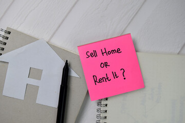 Sell Home or Rent it? text write on sticky notes isolated on office desk.