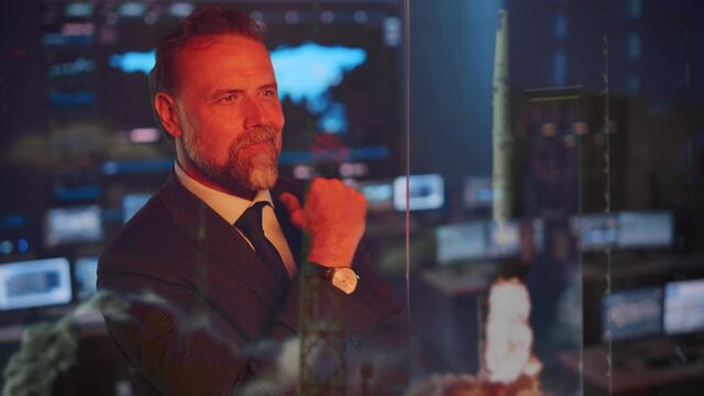 Emotional Happy Male Flight Controller Being Nervous Before a Very Important Space Rocket Launch. Powerful Portrait with a Reflection in a Mission Control Center. Computer Screens in the Background.