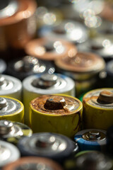 Close up of positive ends of discharged batteries of different sizes and formats, selective focus....