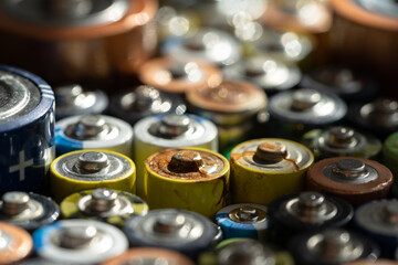Close up of positive ends of discharged batteries of different sizes and formats, selective focus....