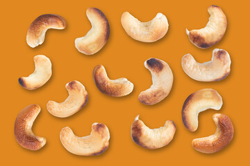 Cashews pattern on a orange background. Nuts creative layout. Top view