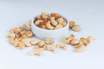 roasted cashew nuts in the bowl on white background