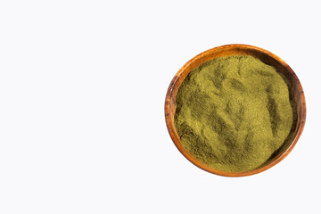 Organic green powder in the wooden bowl - text space
