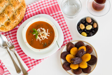 Traditional Turkish Tomato Soup with cheese and fresh mint garnised,close-up taken on Ramadan,Iftar Table.