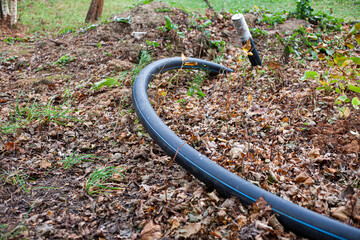 The cable sticks out of the ground.