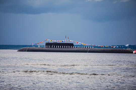 A line of modern russian military submarine cruisers in the row, northern fleet and baltic sea fleet in the open sea, submarine during military exercise