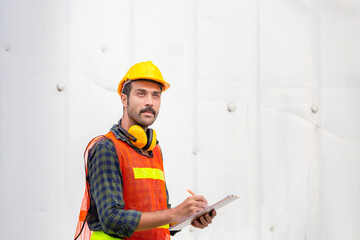 Factory worker man holding clipboard checklist checking containers box from cargo