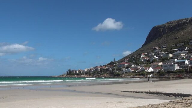 Summer day video of spectacular Fish Hoek harbour, suburb buildings, lagoon and ocean beach. Fish Hoek is Cape Town residential suburb on False Bay of Cape Peninsula, Western Cape, South Africa
