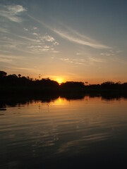 Fototapeta premium Sunset on a river deep in the Amazon rainforest of South America