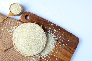 White sesame seeds isolated on a white wooden background