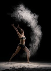 Fototapeta na wymiar Slim female dancer throwing dust in air