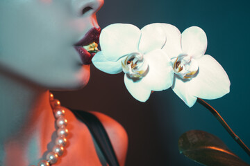 Female lips and orchid. Natural beauty lip.