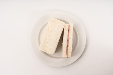 Sandwich made by white bread, ham and mayonnaise on white background.