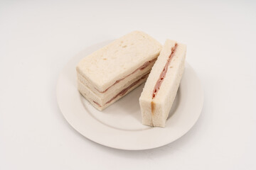 Sandwich made by white bread, ham and mayonnaise on white background.